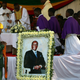 Soldiers stand beside a picture of former Zimbabwean President Robert Mugabe during a church service before his burial at his rural village in Kutama, Zimbabwe, Sept. 28, 2019.